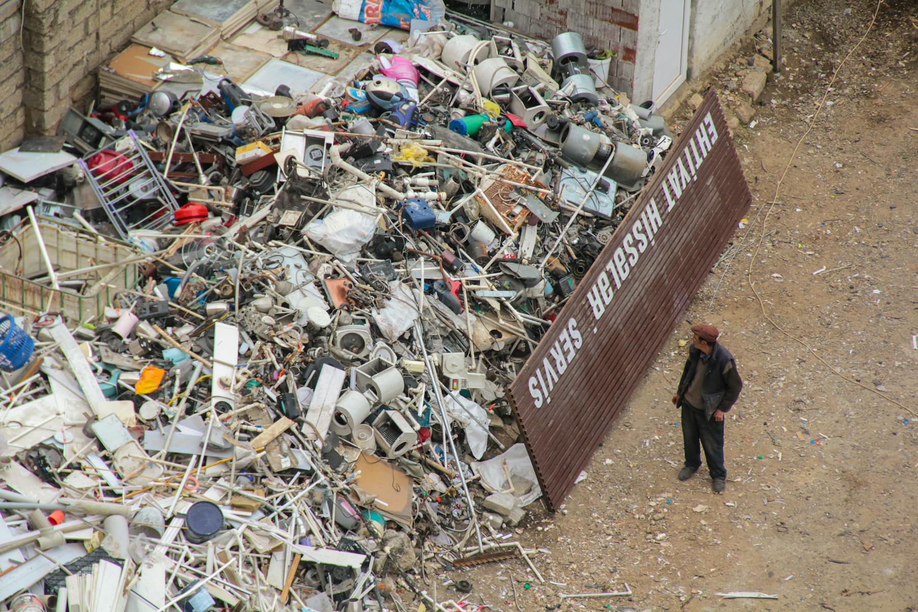 Crew member sorting a large junk pile